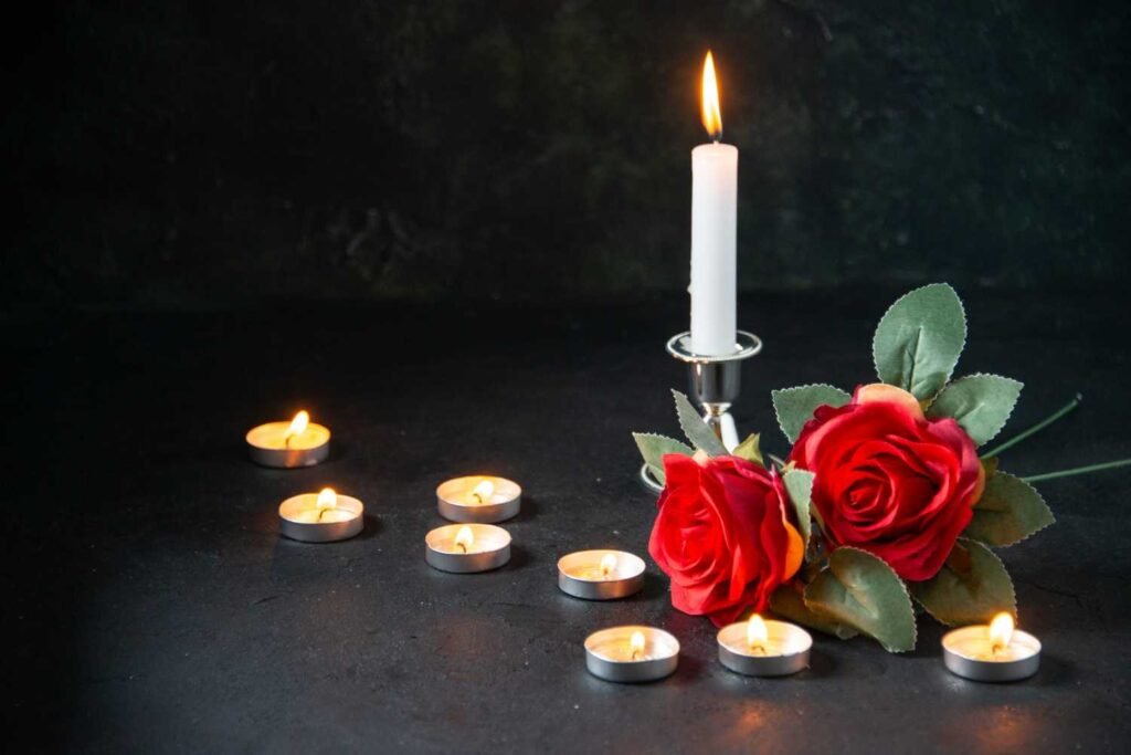 Front view burning candles as memory for fallen dark surface Front view burning candles as memory for fallen dark surface