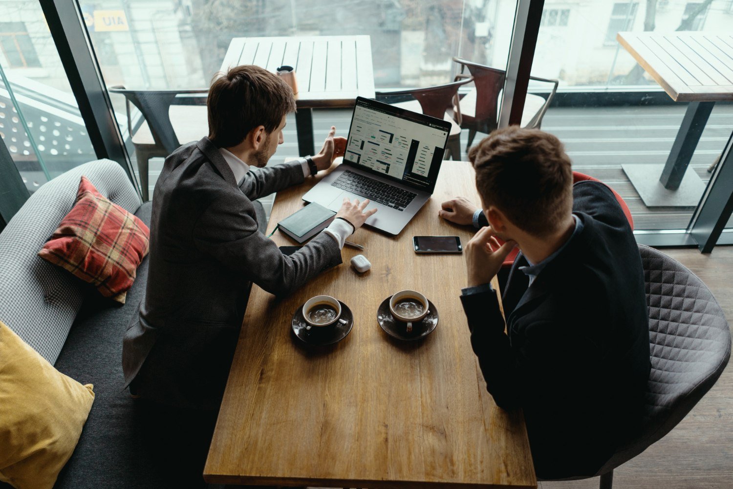 Two young businessman having a successful meeting at restaurant. Two young businessman having a successful meeting at restaurant.